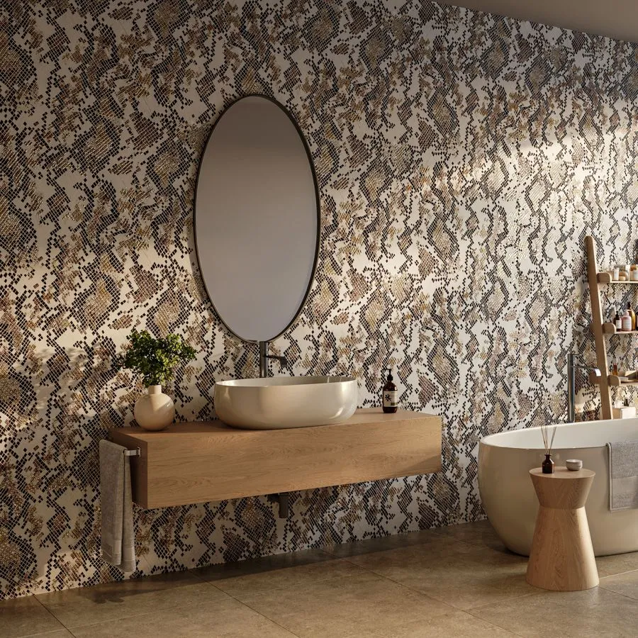 Vesper reimagines a classic snakeskin pattern and its mesh-like geometry and vibrant colors to stunning effect. The hand painted pattern is selectively edited to create negative space, revealing shimmering hues of copper, indigo, green, or grey.  Digitally printed on vinyl with metallic foil, Vesper reflects light in shifting patterns, demanding attention and creating a dynamic surface that adds depth and drama to any space.